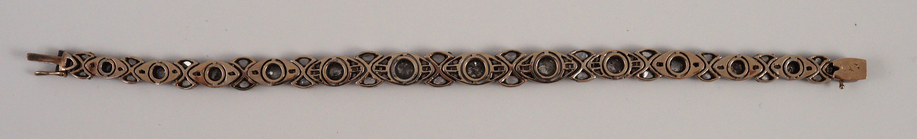 An early to mid 20th century continental gold and silver, graduated diamond and sapphire set line bracelet